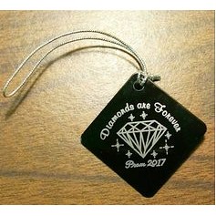 1.5" x 1.5" Diamond or square shaped ornament with a laser engraved imprint and metallic string.