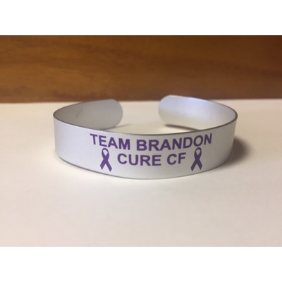 Aluminum cuff bracelet (5.5" x 1/2" wide) with a screen printed imprint. Made in the USA